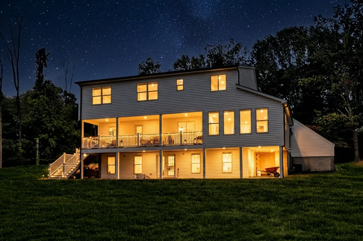 Rear of a renovated Princeton residence lit at dusk